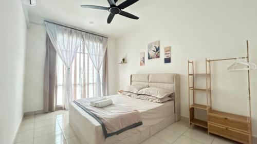 a bedroom with a bed with a ceiling fan at Zahran Homestay in Papar