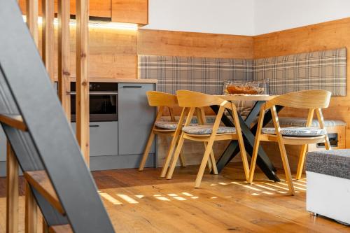 a kitchen with a table and chairs in a room at Nora Apartments in Dolní Morava