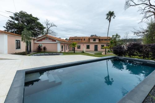 a swimming pool in front of a house at ZEN & ART - Alojamento de Charme in Santa Maria Da Feira