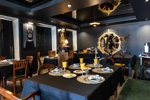 a dining room with tables and chairs and a mirror at ZEN & ART - Alojamento de Charme in Santa Maria Da Feira