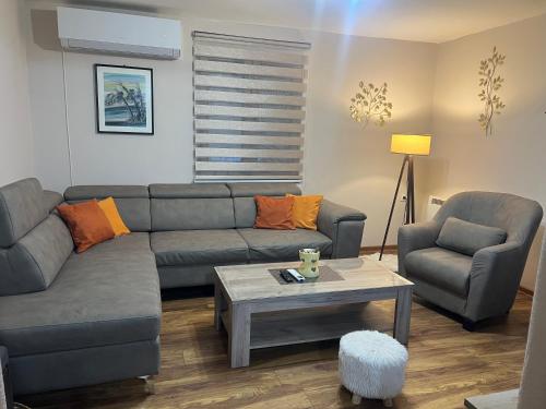 a living room with a couch and a table at Vikendica Silenzio in Cetinje