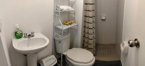 a small bathroom with a toilet and a sink at Cusi Wasi AQP in Arequipa