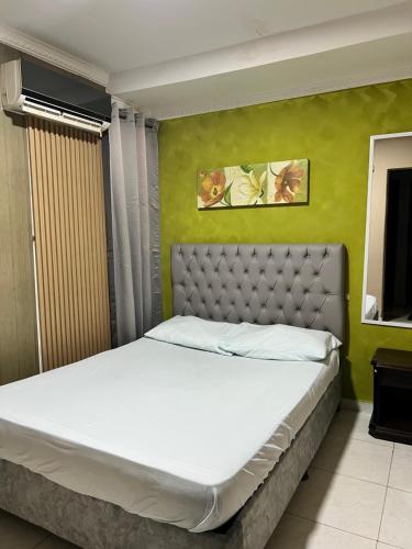 a bedroom with a large bed with white sheets at NaPoles valledupar Hotel in Valledupar