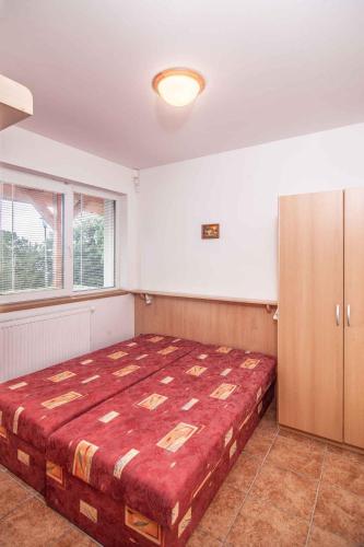 a bedroom with a large bed and a window at Studio with Pool in Benecko-Riesengebirge 2218 in Benecko