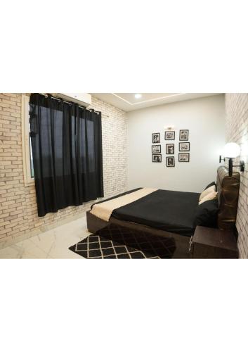 a bedroom with a bed and a couch at Raskunj Farm in Noida