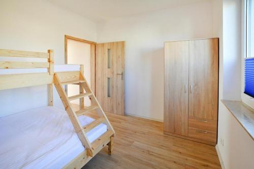 a bedroom with a bunk bed and a closet at Comfortable holiday homes with a summer pool in Jarosławiec