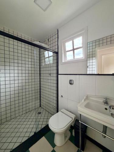 a bathroom with a toilet and a sink at BeInn - Short Stay Collection Penedo in Itatiaia