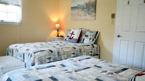 two beds in a room with a bedskirts at 409 Princeton in Cape May Point