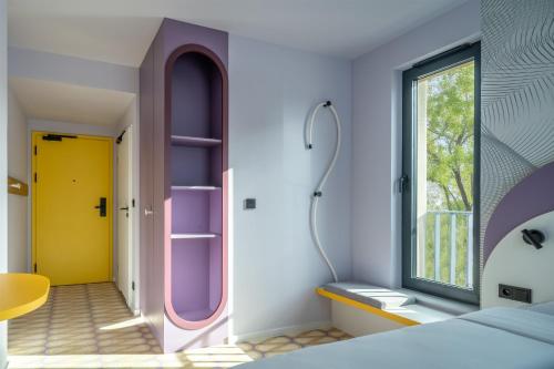 a bedroom with a bed and a window at Prize by Radisson, Gdansk in Gdańsk