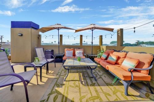 a patio with couches and tables and umbrellas at Contemporary Value 4 Bdr, with Rooftop Deck- 303 home in Newport Beach