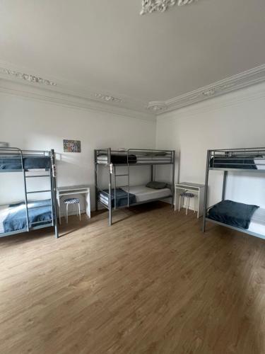 three bunk beds in a room with a wooden floor at Varandas do Chiado - Coliving in Lisbon