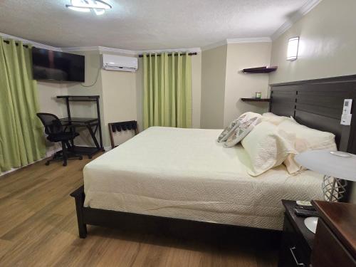 a hotel room with a bed and a desk at Sunset Haven in Wallhouse