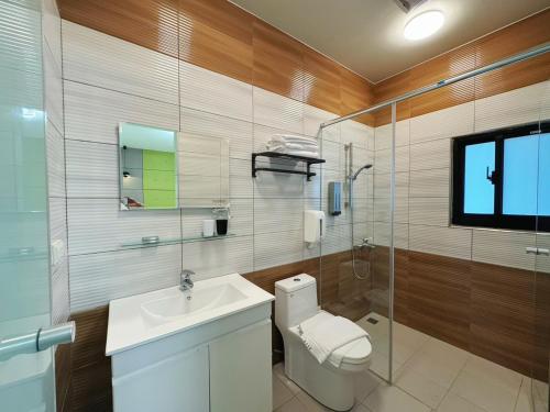 a bathroom with a toilet and a sink and a shower at 海洋星空民宿 in Magong