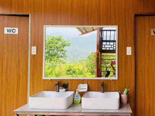 a bathroom with two sinks and a window at Sống Chill Homestay in Nam Yên