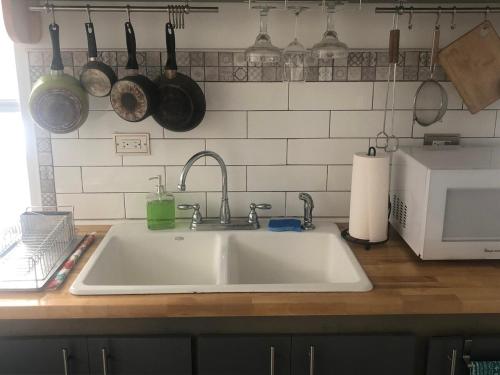 a kitchen counter with a sink and pots and pans at Little haven by the woods in Peekskill