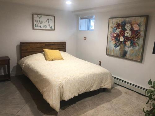 a bedroom with a bed with a yellow pillow on it at Little haven by the woods in Peekskill