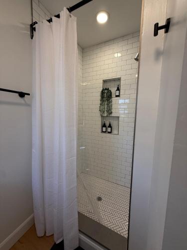 a shower with a shower curtain in a bathroom at A home in Niagara falls- The Maple and Mist in Niagara Falls