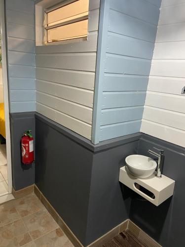 a small bathroom with a toilet in the corner at Exceptional bungalow with private pool in Rivière-Pilote