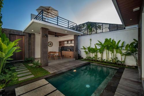 a swimming pool in the backyard of a house at Alima Villa Ubud in Ubud