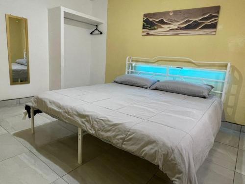 a bed in a room with a white bed frame at Your modern getaway with uniquely stylish comfort in Nuevo Casas Grandes