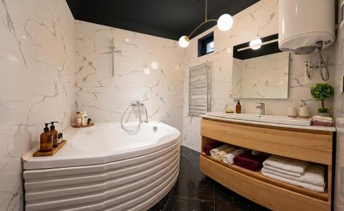 a bathroom with a tub and a sink at Pirshagi Villa in Baku
