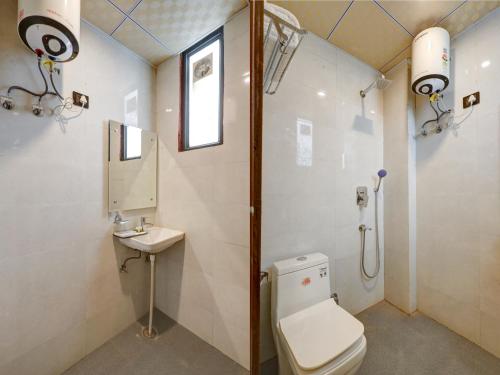 a bathroom with a toilet and a sink at MAXX Elite in Gurgaon