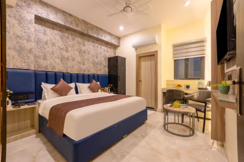 a hotel room with a bed and a kitchen at MAXX Elite in Gurgaon