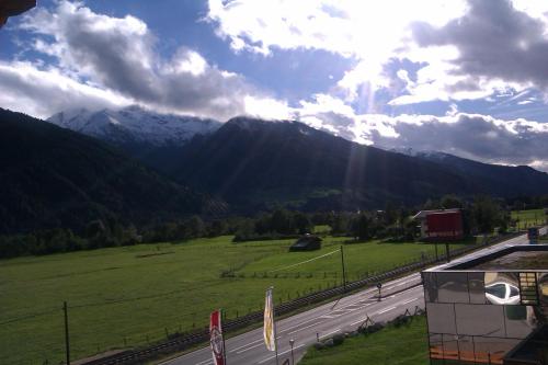 a view of a road with mountains in the background at Hotel Gasthof Schweizerhaus in Stuhlfelden