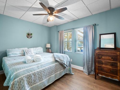 a bedroom with a bed and a ceiling fan at Sunset Cove - Large Cove, Gorgeous Sunsets, Amenities Galore! in Bremen
