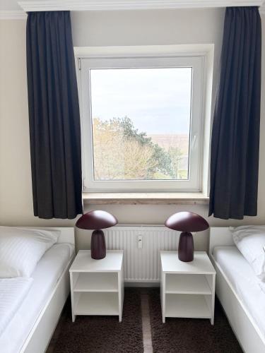 a room with two beds and a window at Germania-60 in Böhl