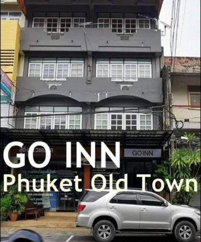 a silver car parked in front of a building at GO INN Phuket old Town in Phuket