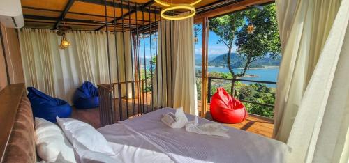 a bedroom with a bed and a large window at Victoria Sky Crest - Kandy in Teldeniya
