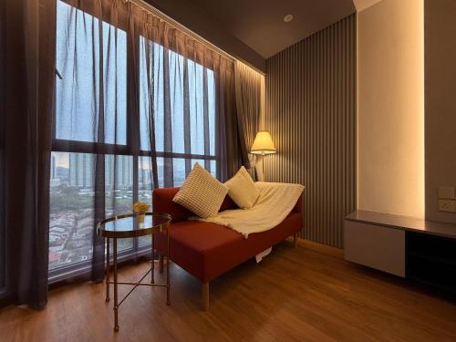 a living room with a couch and a large window at The Aerie in Kuala Lumpur