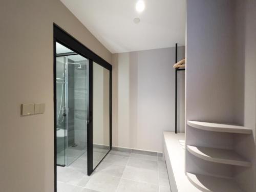 a bathroom with a walk in shower and a glass door at The Aerie in Kuala Lumpur