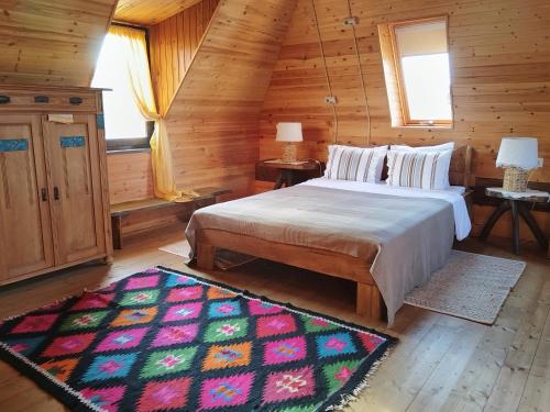 a bedroom with a large bed in a log cabin at Small Apartment in Breb s Cosy Barn in Breb