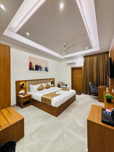 a bedroom with a large bed in a room at Arth Suites Lucknow Gomti Nagar in Lucknow