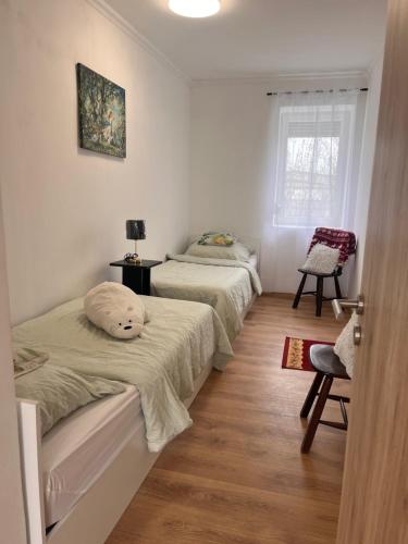a bedroom with two beds and a window at Ladislaus Garden Suites in Cegléd
