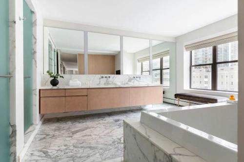 a bathroom with a large tub and a large mirror at Hotel 55 Chicago Downtown in Chicago