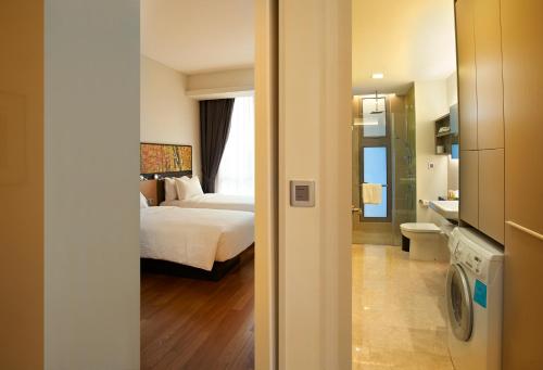 a hotel room with a bed and a bathroom at The Signature Hotel & Serviced Suites Kuala Lumpur in Kuala Lumpur
