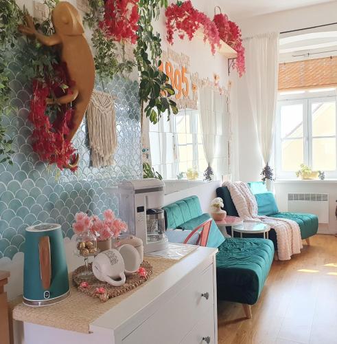 aefully decorated living room with a couch and a table at Casa 1895 , Boutique Stay in a Historic Townhouse near the Beer Fountain in Žalec