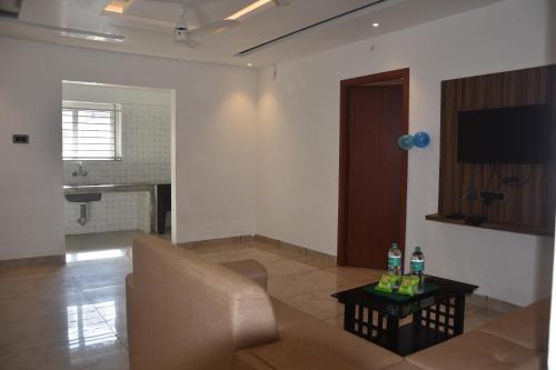 a living room with a couch and a table at Bihotels And Resorts in Yercaud
