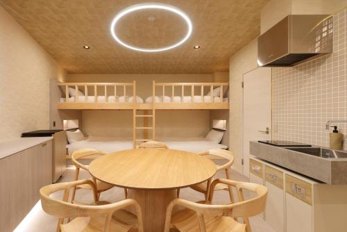 a kitchen with a table and chairs in a room at HAKORU Tokyo 八炬ル in Tokyo