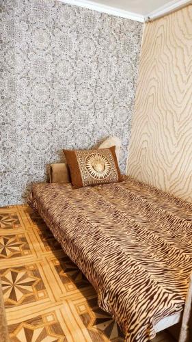 a bed with pillows on it in a room at Дарина in Chornomorsk