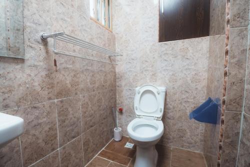 a bathroom with a toilet and a sink at Spacious 3-Bedroom in Central Ikeja in Ikeja