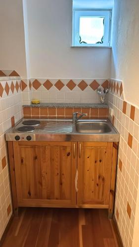 a small kitchen with a sink and a window at Hotel Relax in Wachenroth