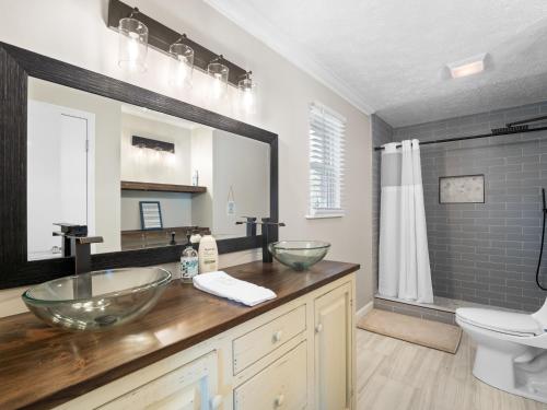 a bathroom with two vessel sinks and a toilet at Sunset Cove - Large Cove, Gorgeous Sunsets, Amenities Galore! in Bremen