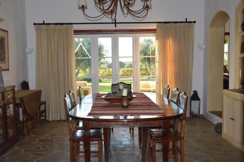 a dining room with a wooden table and chairs at Monte da Boavista - Country family house in Alter do Chão