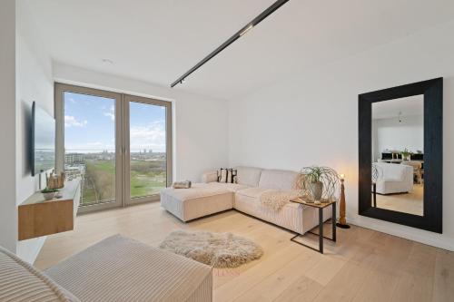 a living room with a white couch and a large window at Zilt 15 in Ostend