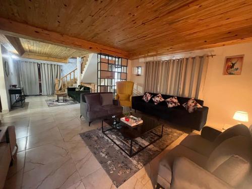 a living room with a couch and a table at Noon Villa in Kanethi