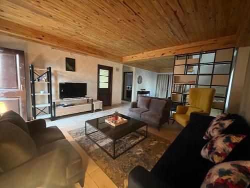 a living room with a couch and a table at Noon Villa in Kanethi